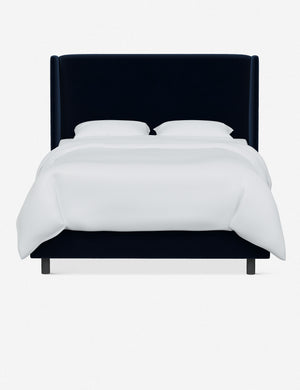 Adara navy velvet upholstered bed.