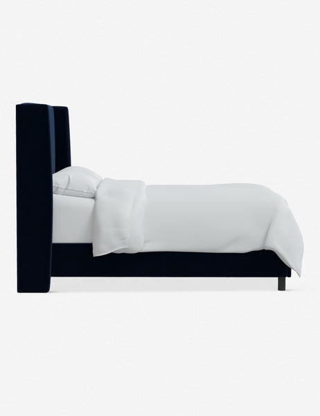 #color::navy-velvet #size::twin #size::full #size::queen #size::king #size::cal-king | Side view of Adara navy velvet upholstered bed.