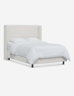 Angled view of Adara white velvet upholstered bed.