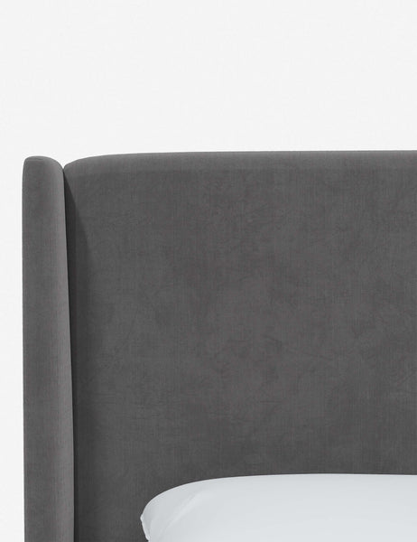 #color::steel-velvet #size::twin #size::full #size::queen #size::king #size::cal-king | Close-up of the subtle winged headboard and trim lines on the Adara gray velvet upholstered bed.