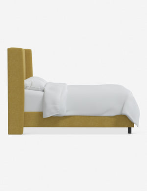 Side view of the Adara yellow linen upholstered bed.