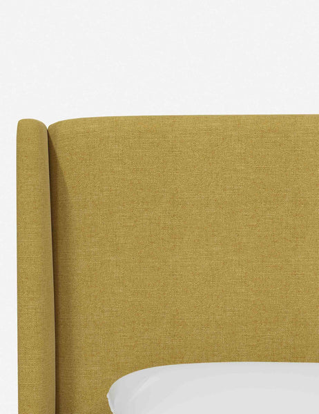 #color::golden-linen #size::twin #size::full #size::queen #size::king #size::cal-king | Close-up of the subtle winged headboard and trim lines on the Adara yellow linen upholstered bed.