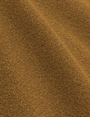 Close-up of the ochre boucle fabric on the Clementine platform bed