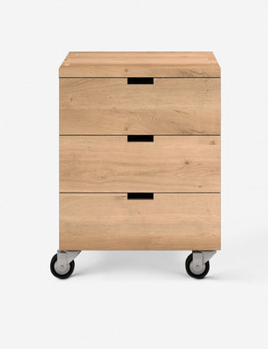 Tygan three drawer wooden filing cabinet featuring a wheeled design with cutout drawer pulls