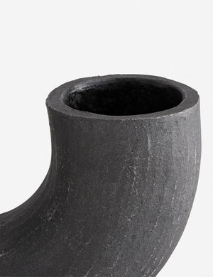 Close-up of the right half of the Damien half-circle sculpture vase by Ateriors with matte black glaze finish
