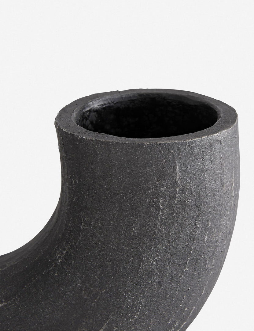 | Close-up of the right half of the Damien half-circle sculpture vase by Ateriors with matte black glaze finish