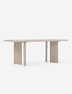 Angled view of the Sun at six crest white oak dining table with curved legs