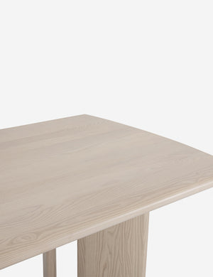 Close-up of the right half of the Sun at six crest white oak dining table with curved legs
