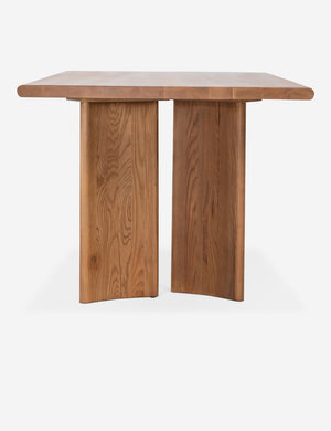 Side view of the Sun at six crest sienna wood dining table with curved legs