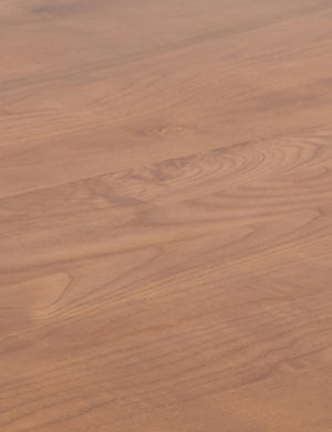 Detailed view of the sienna wood on the Sun at six crest sienna wood dining table with curved legs