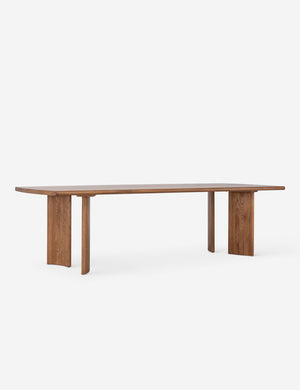 Angled view of the Sun at six crest sienna wood dining table with curved legs