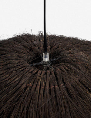 Close-up of the top of the Paige black plush pendant light with palm tree fibers