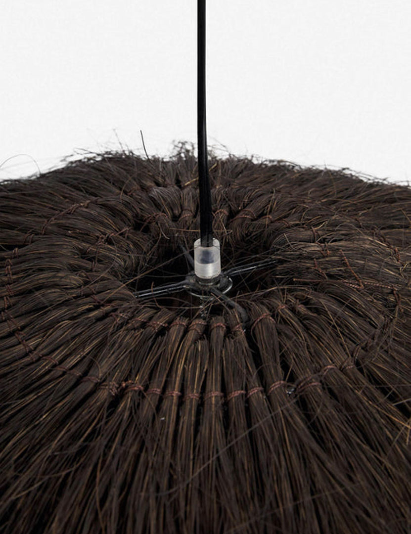 | Close-up of the top of the Paige black plush pendant light with palm tree fibers 