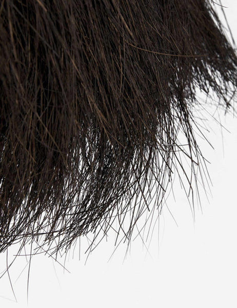 | Close-up of the ends of the palm tree fibers on the Paige black plush pendant light 