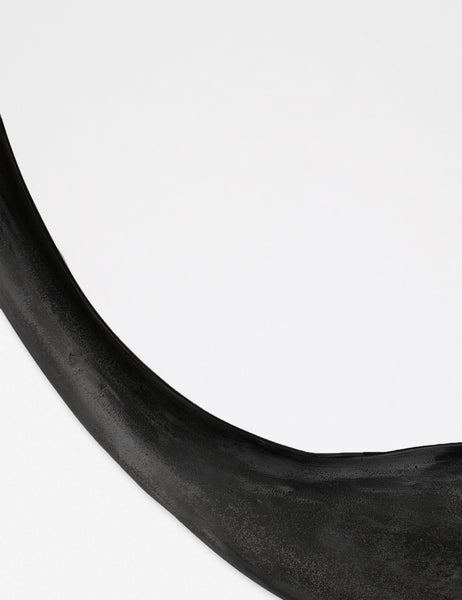 #color::black | Close-up of the inorganic frame design on the Doreen black organic round mirror 