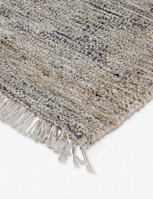 Close-up of the natural fiber fabric and fringed ends on the corner of the Ismenia distressed persian rug