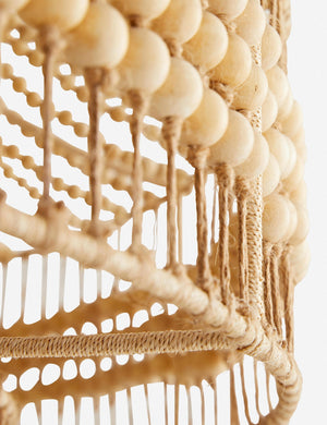 Close-up of the wooden beads and abaca rope on the bottom of the Tulane open-woven wooden chandelier by Arteriors