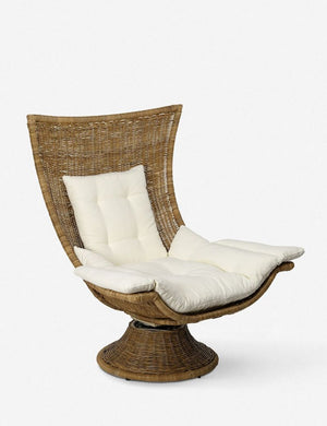 Angled view of the Akila curvy rattan swivel chair