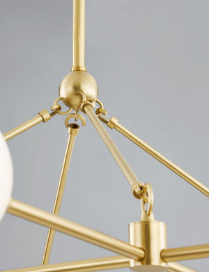 Close up of the frame of the Helia slim frame modern brass chandelier.
