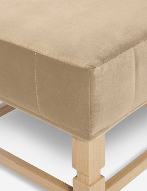 Close-up of the corner on the cushion of the Ambleside Brie beige velvet ottoman