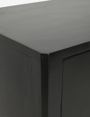 Close-up of the joint work on the upper left corner of the Anabella black wood console table with silver drawer pulls