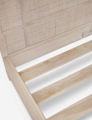Detailed-shot of the wooden support beams on the bottom of the Brooke whitewashed platform bed with cane paneling
