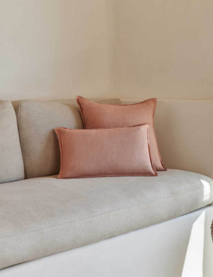 The arlo Terracotta flax linen pillow in its lumber and square sizes sit together on a natural linen sofa