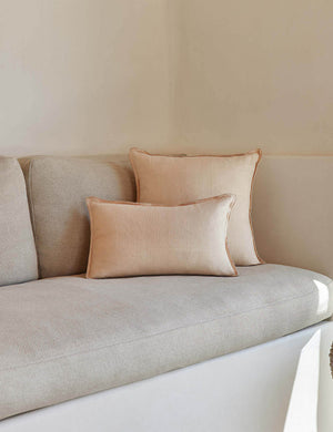 The arlo Blush pink flax linen pillow in its lumber and square sizes sit together on a natural linen sofa