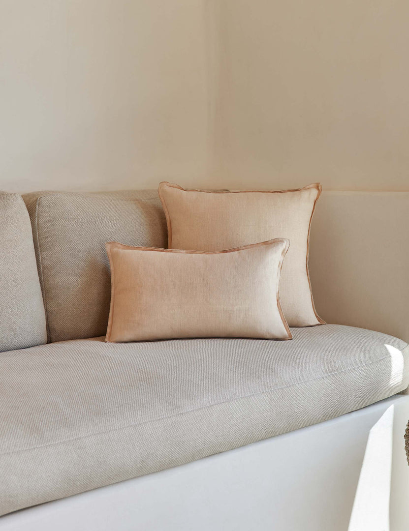 #color::blush #style::lumbar | The arlo Blush pink flax linen pillow in its lumber and square sizes sit together on a natural linen sofa