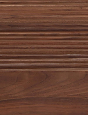Close up view of the Olson mid-century slatted wood bench in walnut.