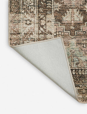 Corner shot of the Billie Rug in clay and sage by Amber Lewis x Loloi with the corner folded over