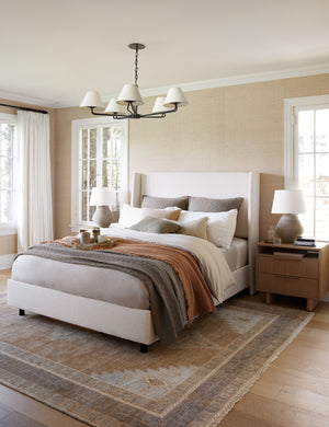 Ojai Cotton Matelasse Pebble Gray Euro Sham by Pom Pom at Home sits on a white framed bed with terracotta, white, and other pebble gray linens