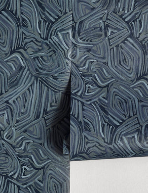 Bequia Wallpaper that features dark blue tones and ripple-like design by Malene Barnett