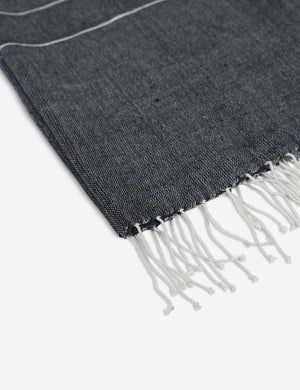 Close-up of the fringed ends on the Melkam onyx gray Hand Towel by Bolé Road Textiles