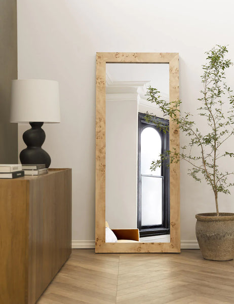 | Bree Burl Wood Rectangular Floor Mirror sits on the corner of a room with a sculptural lamp