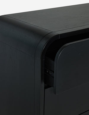 Close-up of the rounded corner and drawer glides on the Brooke 3-drawer black oak dresser