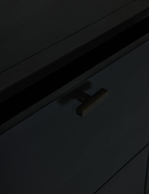 Close-up of the iron pull on the brooke black oak 6-drawer rounded dresser
