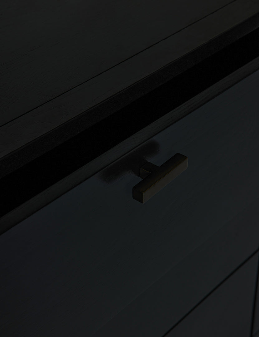 #color::black | Close-up of the iron pull on the brooke black oak 6-drawer rounded dresser