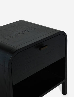 Angled view of the Brooke one drawer black nightstand