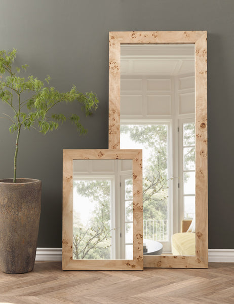 | Bree Burl Wood Rectangular Floor Mirror stands against a gray wall with a smaller burl wood mirror