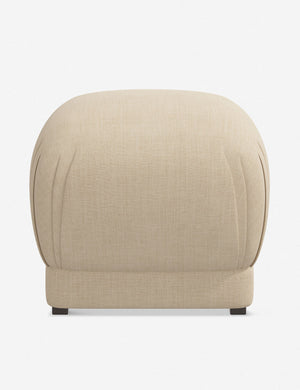 Bailee Natural Linen upholstered ottoman with a pouf-like design and pleated corners