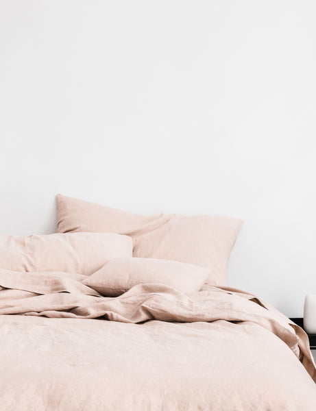 #color::blush #size::queen #size::king | The European Flax Linen blush pink Duvet Cover by Cultiver lays on a bed with other cultiver linens