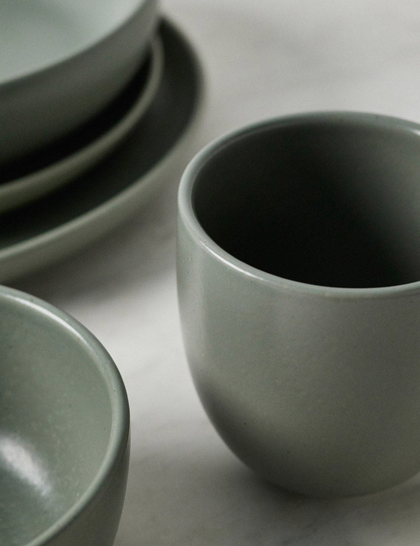 #color::artichoke | Close-up of the mug in the Pacifica artichoke green Dinnerware 5-Piece Place Setting by Casafina