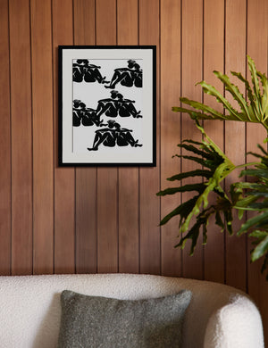 The Over Here Print is hung on a wood paneled wall above a boucle sofa with an olive throw pillow