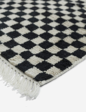 Corner of the tasseled ends on the Black and white Checkerboard Rug by Sarah Sherman Samuel