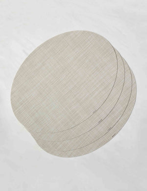 Set of four parchment-toned Mini Basketweave Oval Placemat by Chilewich
