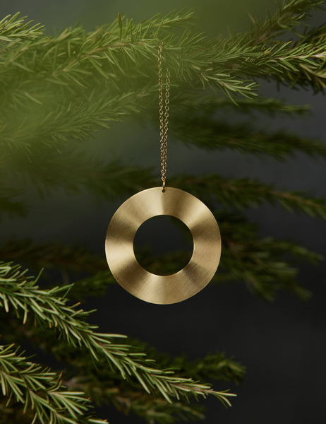 #style::ripple | Circle-shaped Polished Brass Ornament by Circle & Line hung on a christmas tree