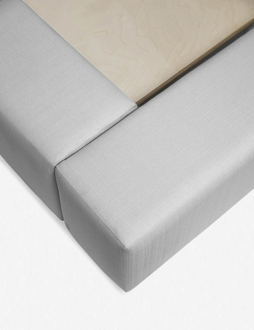 #size::queen #size::king #size::cal-king #color::gray | Close-up of the corner at the end of the Clayton gray upholstered platform bed