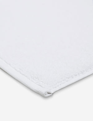 Corner shot of the Cloud loom sustainable white bath mat by coyuchi