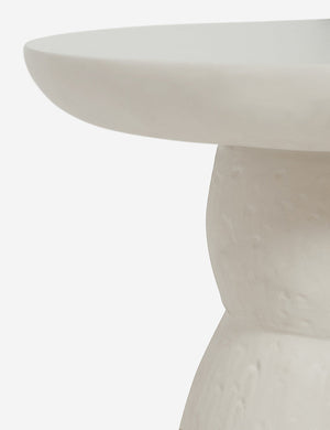 The rim on the top of the Clouded White Round Side Table